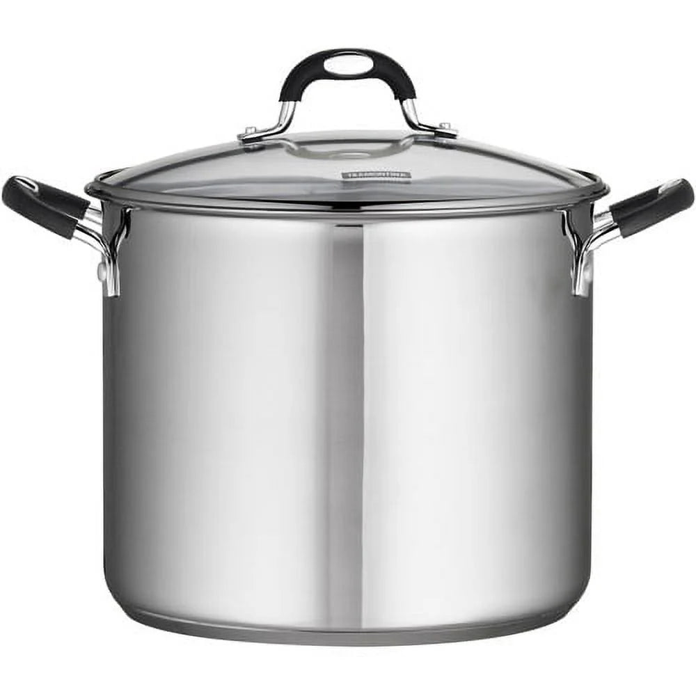 Stainless steel stock pot with a clear lid on a white background