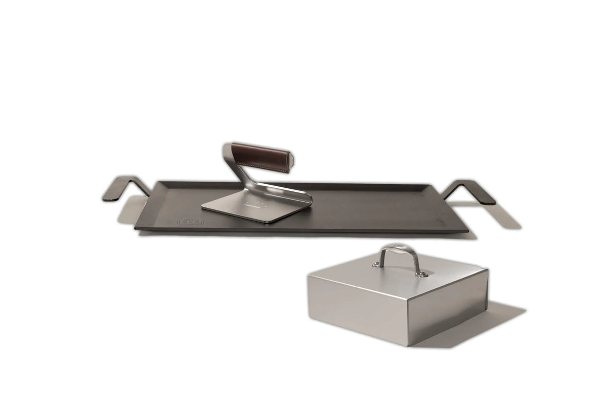 Set of metal grilling tools on a white background
