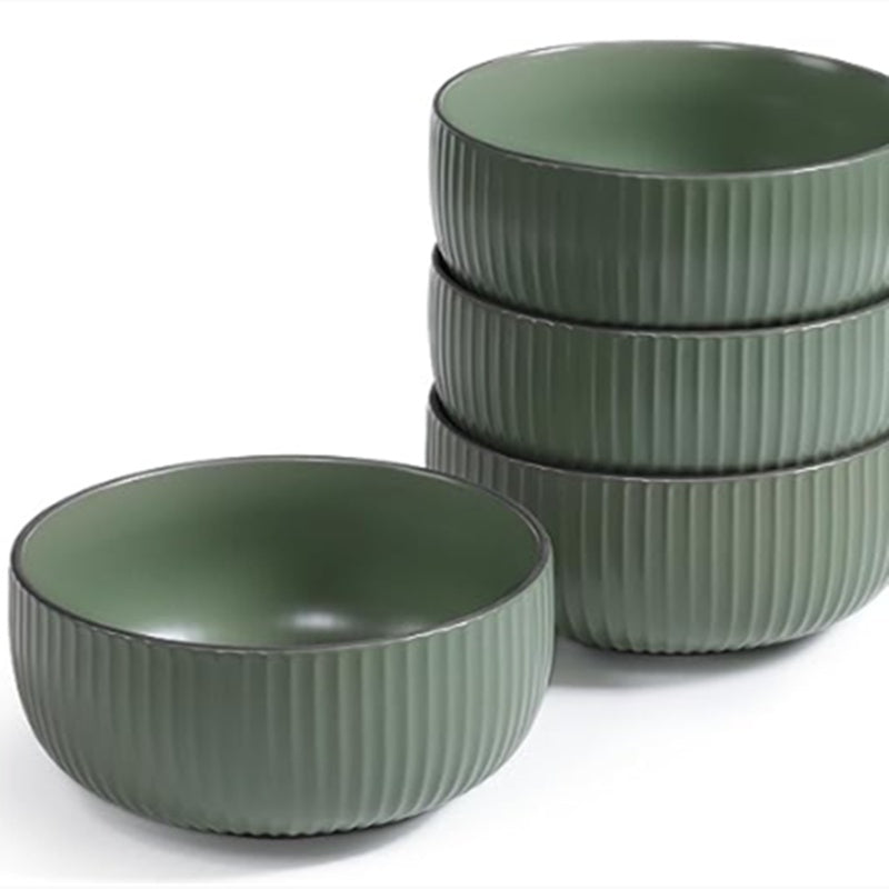 Set of green ceramic bowls with ribbed texture on a white background