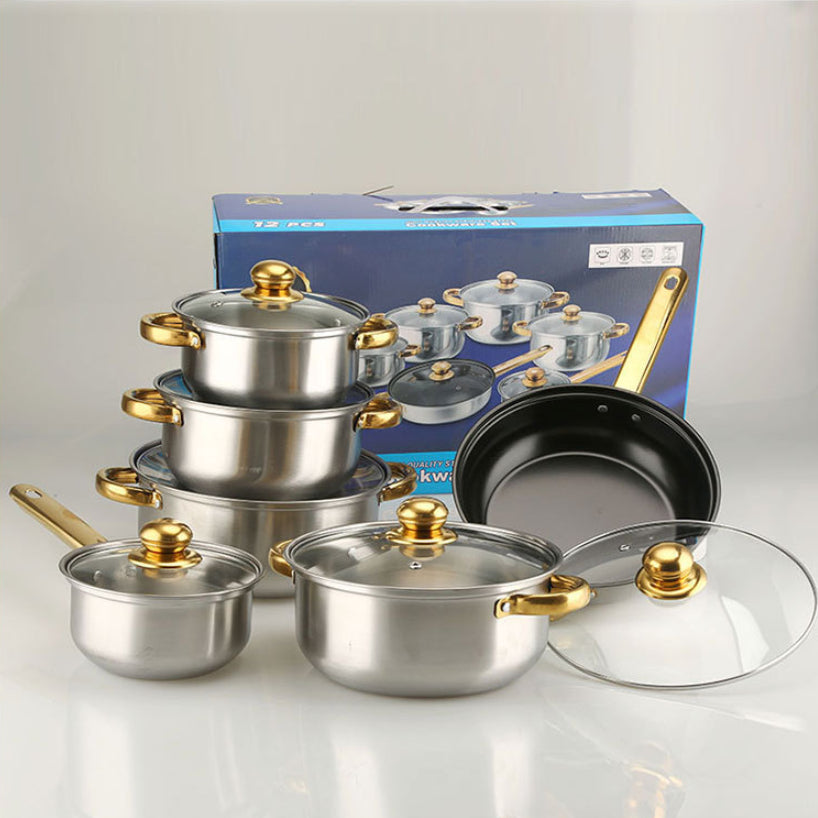 Set of stainless steel cookware with gold handles and lids, displayed in front of a branded box.