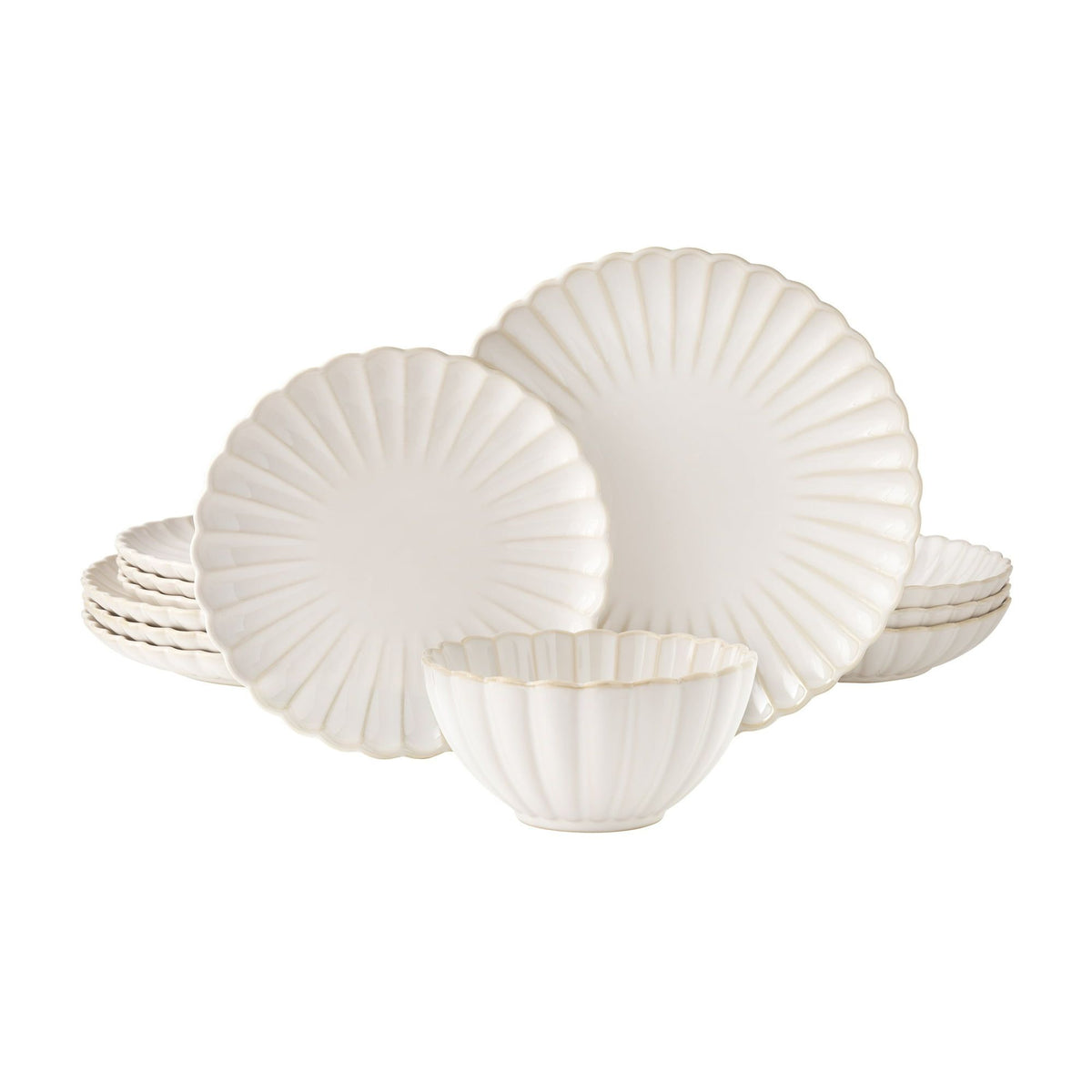 Set of white scalloped plates on a white background