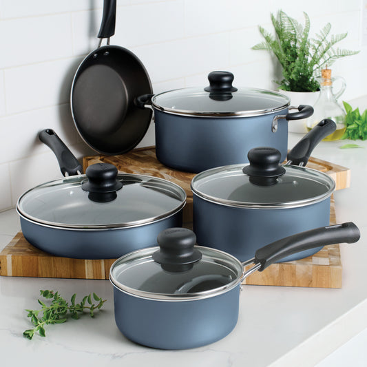 Set of blue cookware with lids on a kitchen counter
