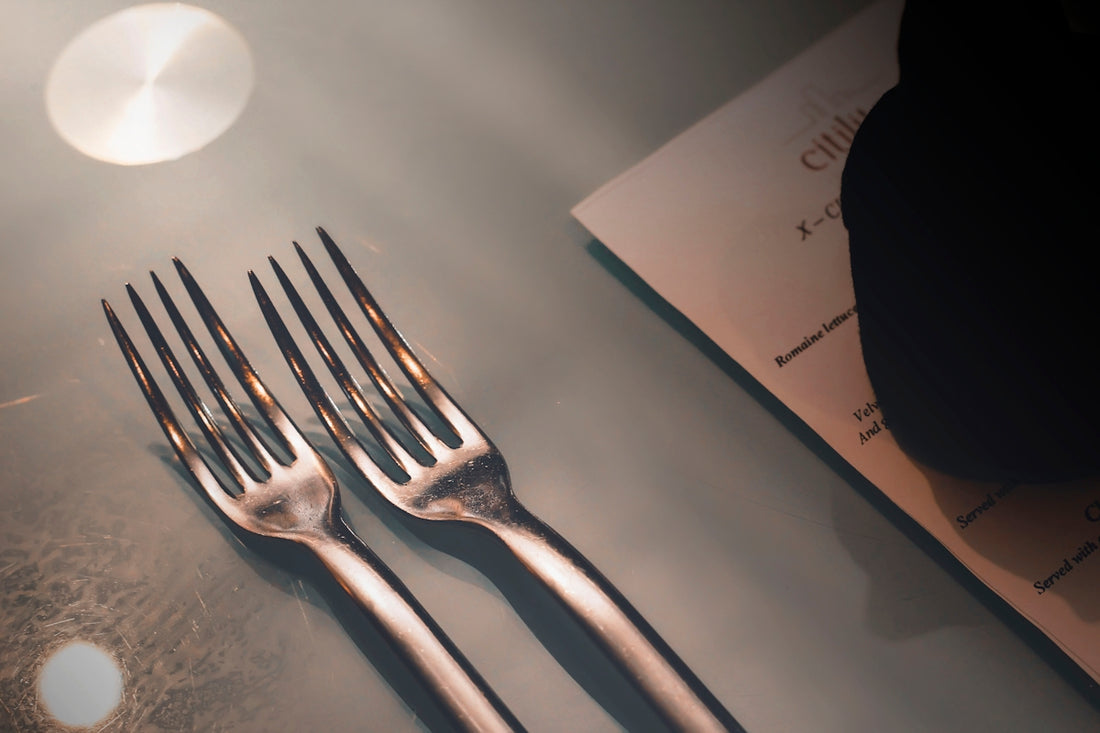 silver fork on white paper