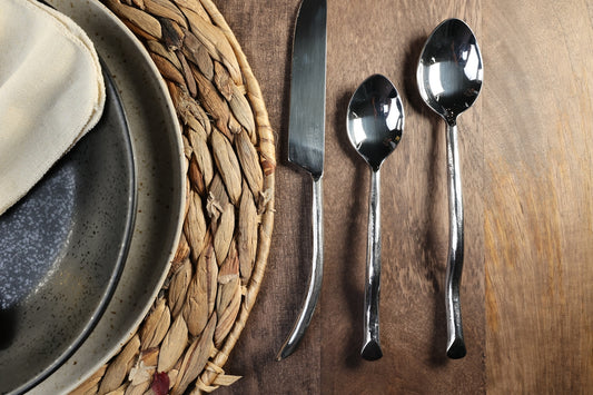 a plate with a spoon and a piece of bread on it