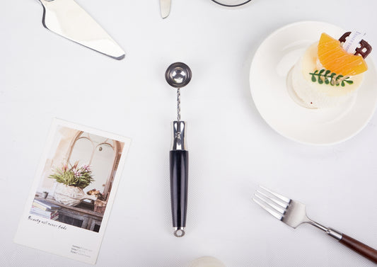 a white table topped with a plate of food and utensils