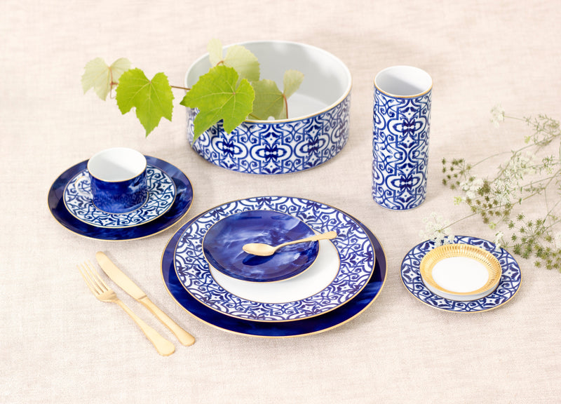 Blue and white ceramic tableware set on a light background