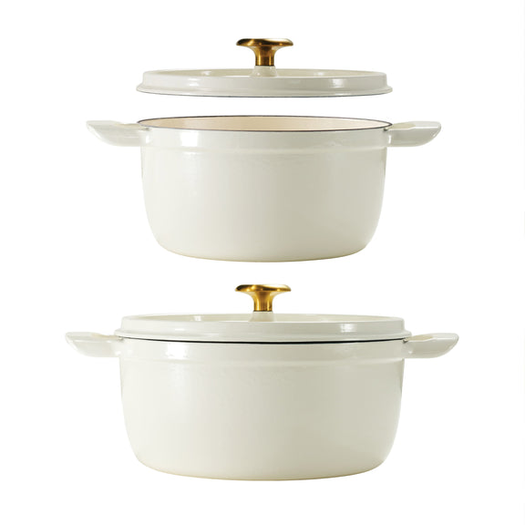 Set of two white dutch oven  cookware pieces with gold lids on a white background