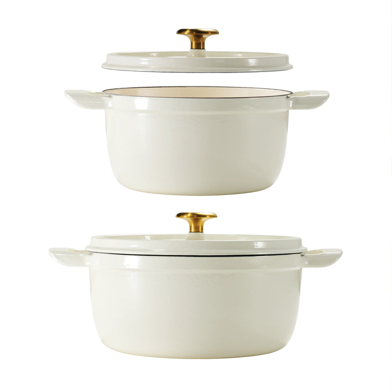 Set of two white dutch oven  cookware pieces with gold lids on a white background
