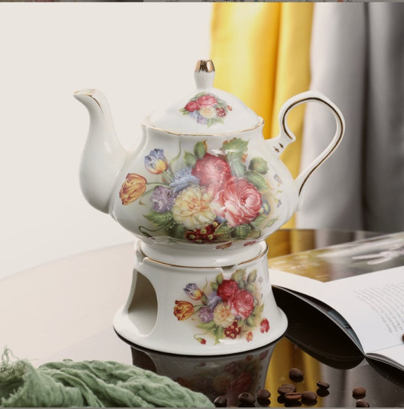 Decorative teapot with floral design on a white surface
