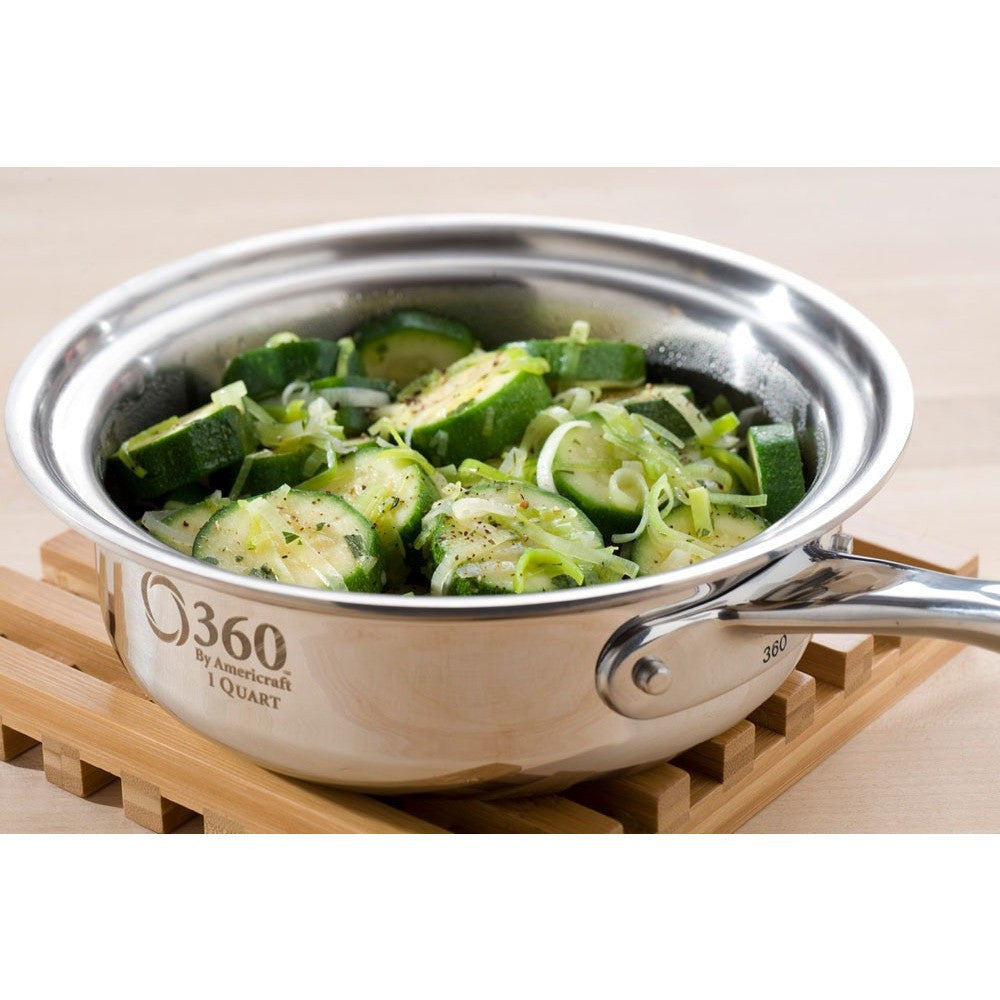 Stainless steel pot with zucchini on a wooden surface