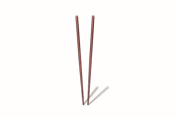 Two thin, metallic stakes on a white background