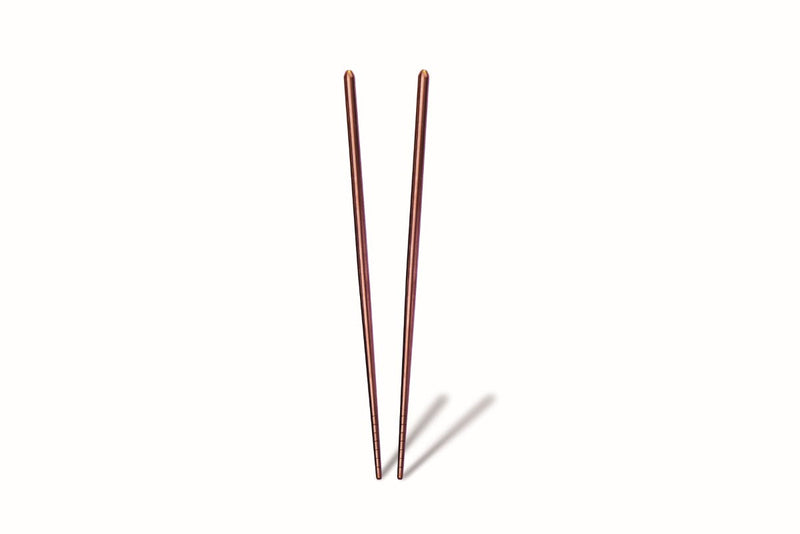 Two thin, metallic stakes on a white background
