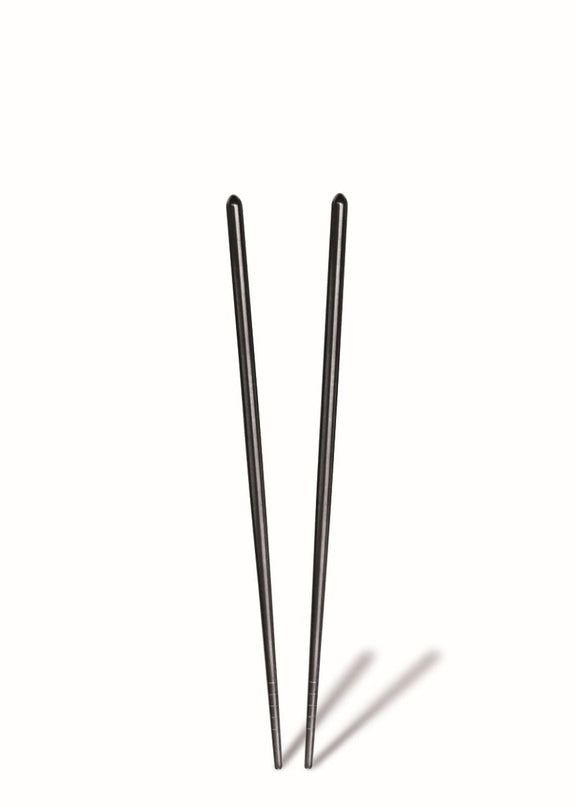 Two black chopsticks on a white background