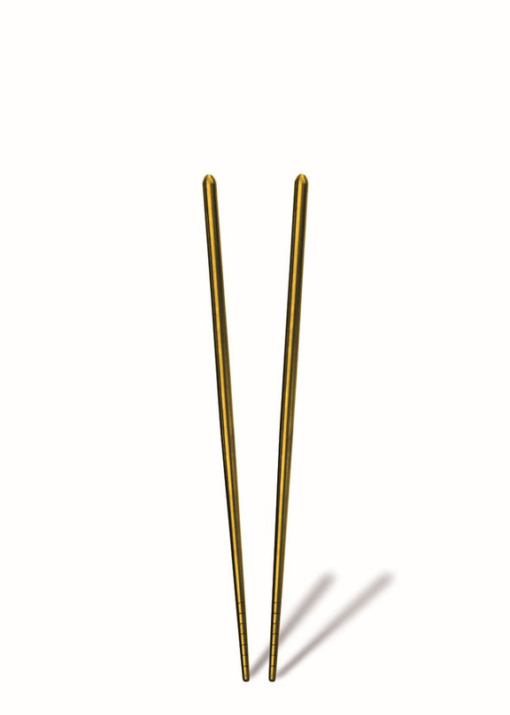 Pair of gold chopsticks on a white background