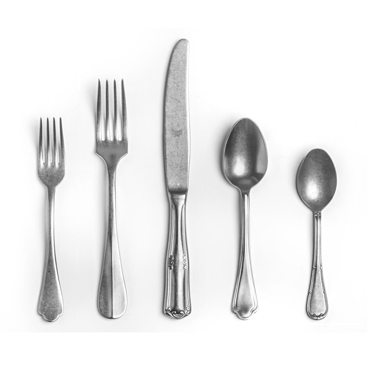 Set of silver cutlery including forks and spoons on a white background