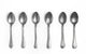 Set of six silver spoons on a white background