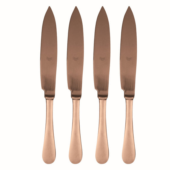Four rose gold knives on a white background