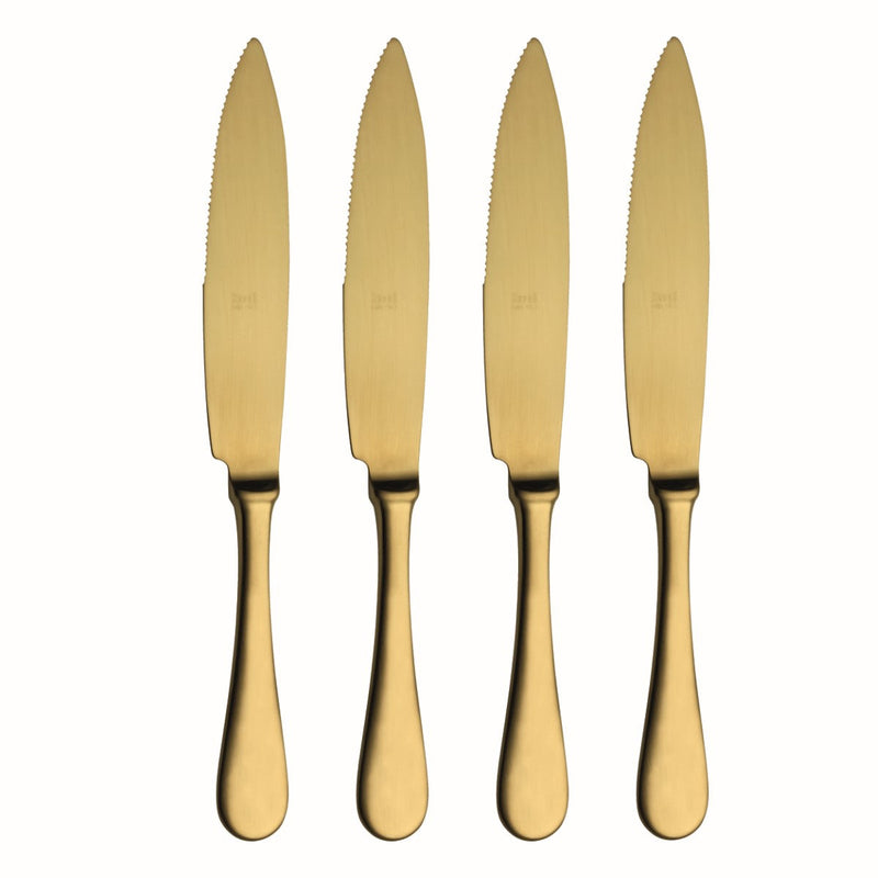 Four gold knives with serrated blades on a white background