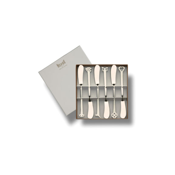 Set of six decorative butter knives in a box on a white background