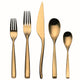 Set of gold-colored cutlery including a knife, two forks, and two spoons on a white background.