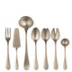 Set of silver flatware including fork, knife, and spoons on a white background