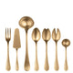 Set of gold flatware including fork, knife, and spoons on a white background