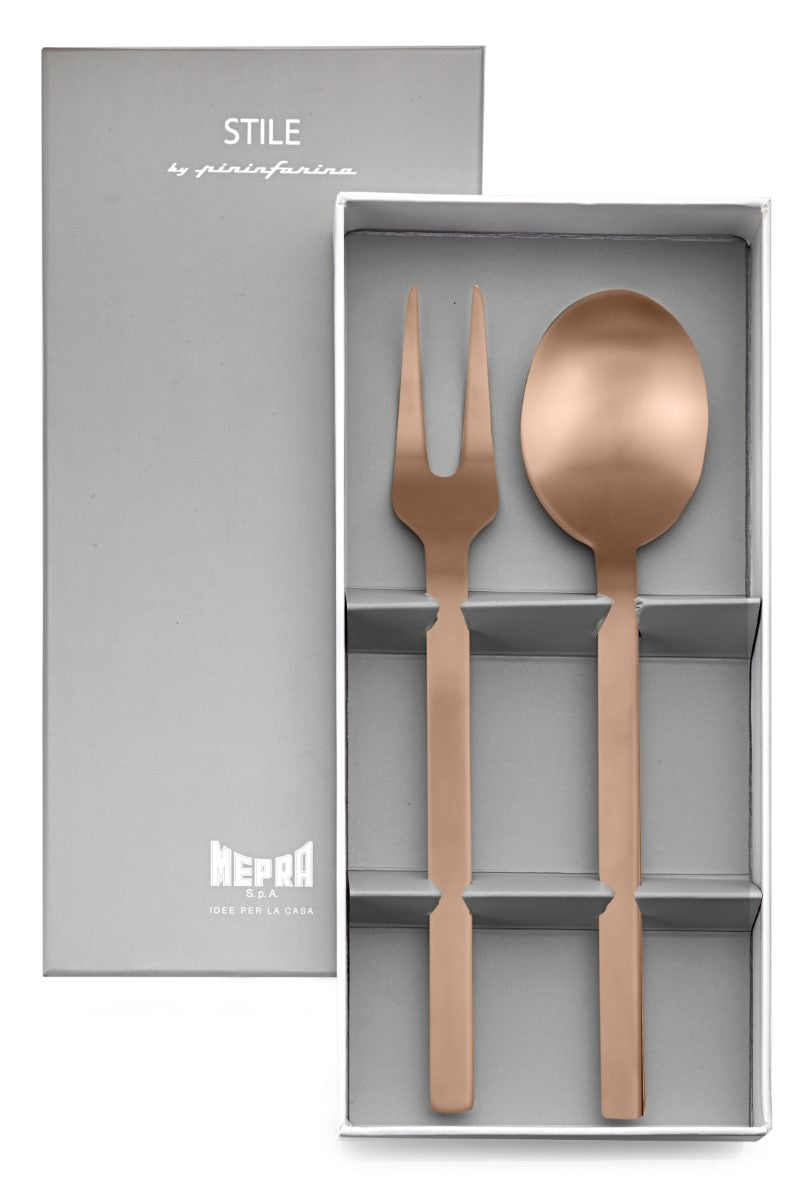 Rose gold spoon and fork set in a gray box with 'Mepra' branding.