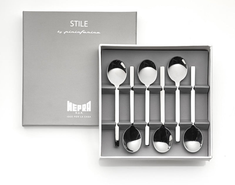 Set of six silver spoons in a gray box with 'Stile' branding.