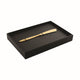 Gold pen in a black display box on a white background