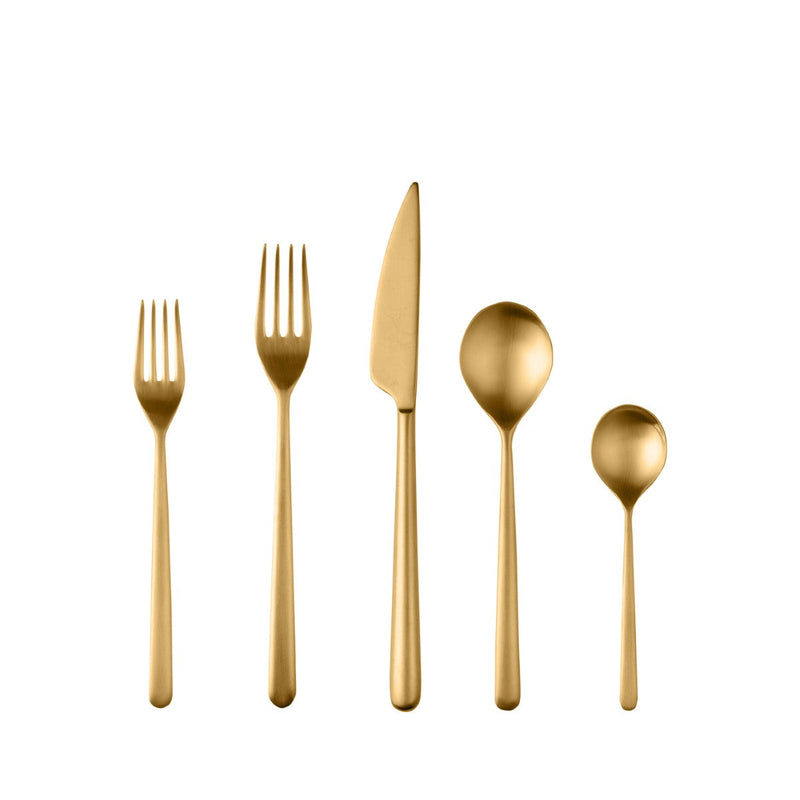 Set of gold cutlery including a knife, fork, and two spoons on a white background