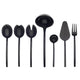 Set of black kitchen utensils including spoons, ladle, spatula, and fork on a white background