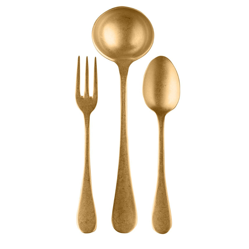 Set of gold-plated cutlery including a fork, spoon, and ladle on a white background.