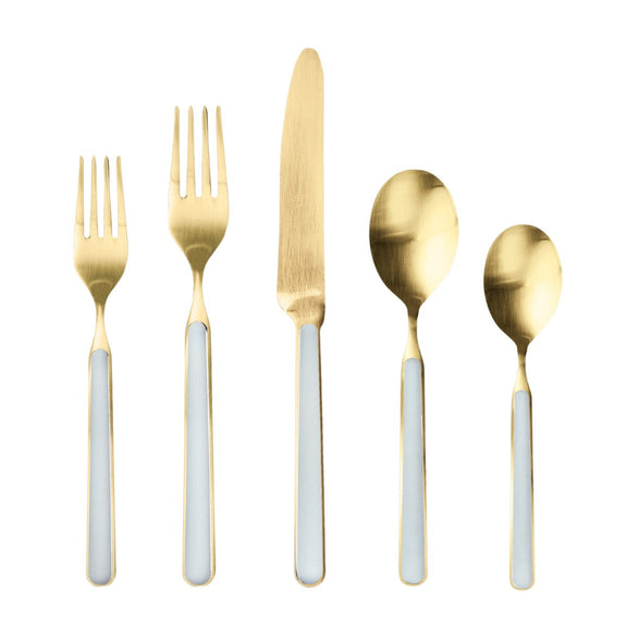 Set of gold cutlery with white handles on a white background