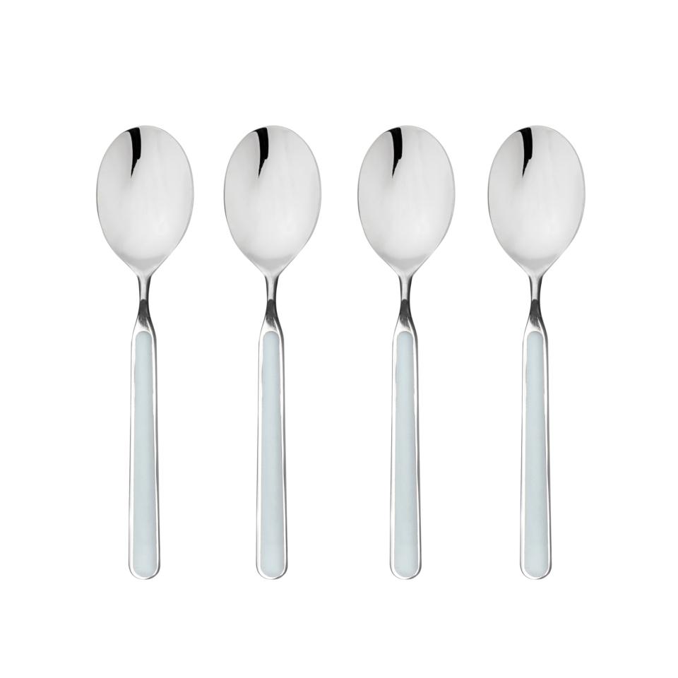 Four silver spoons on a white background