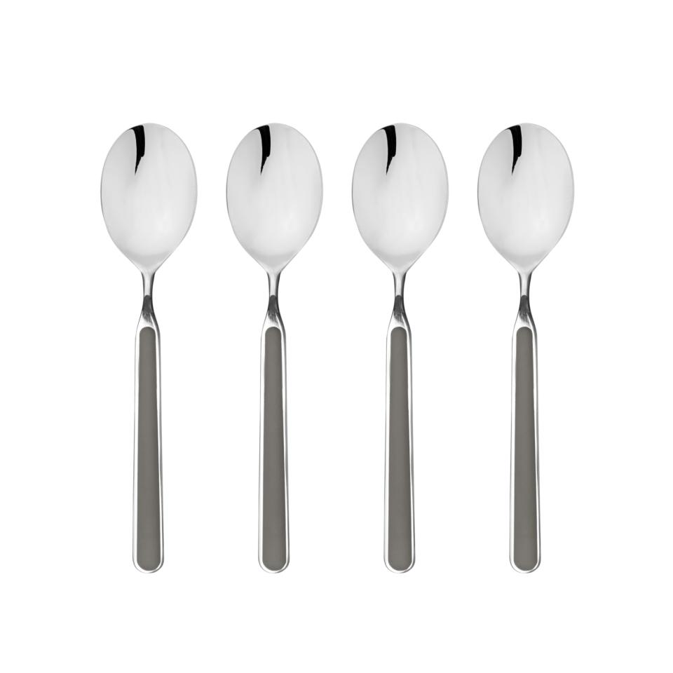 Four silver spoons on a white background