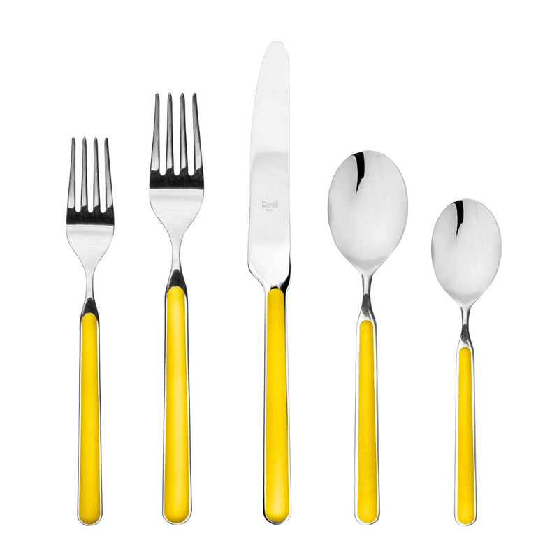 Set of silver cutlery with yellow handles on a white background