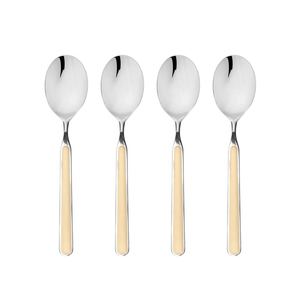 Four silver spoons with beige handles on a white background