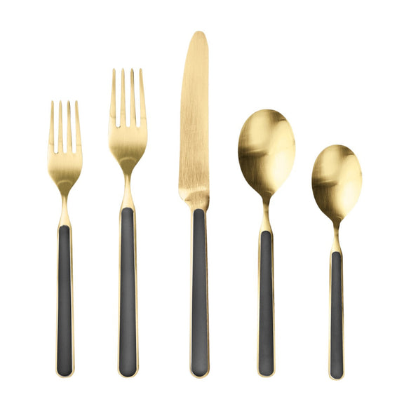 Set of gold cutlery with black handles on a white background