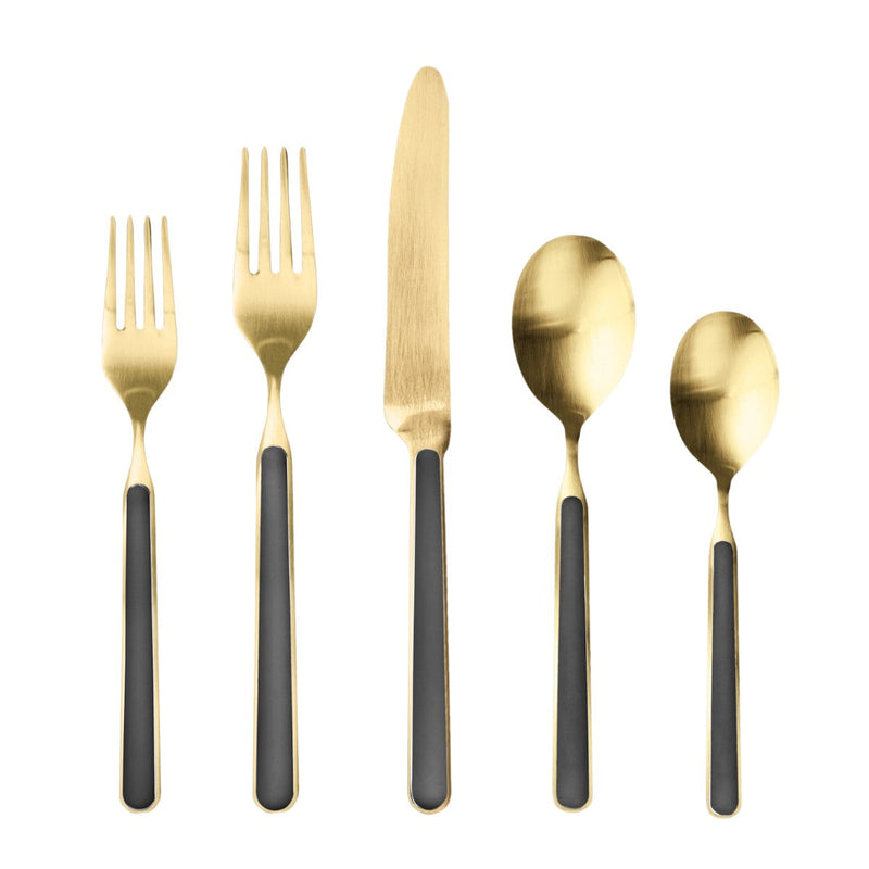 Set of gold cutlery with black handles on a white background