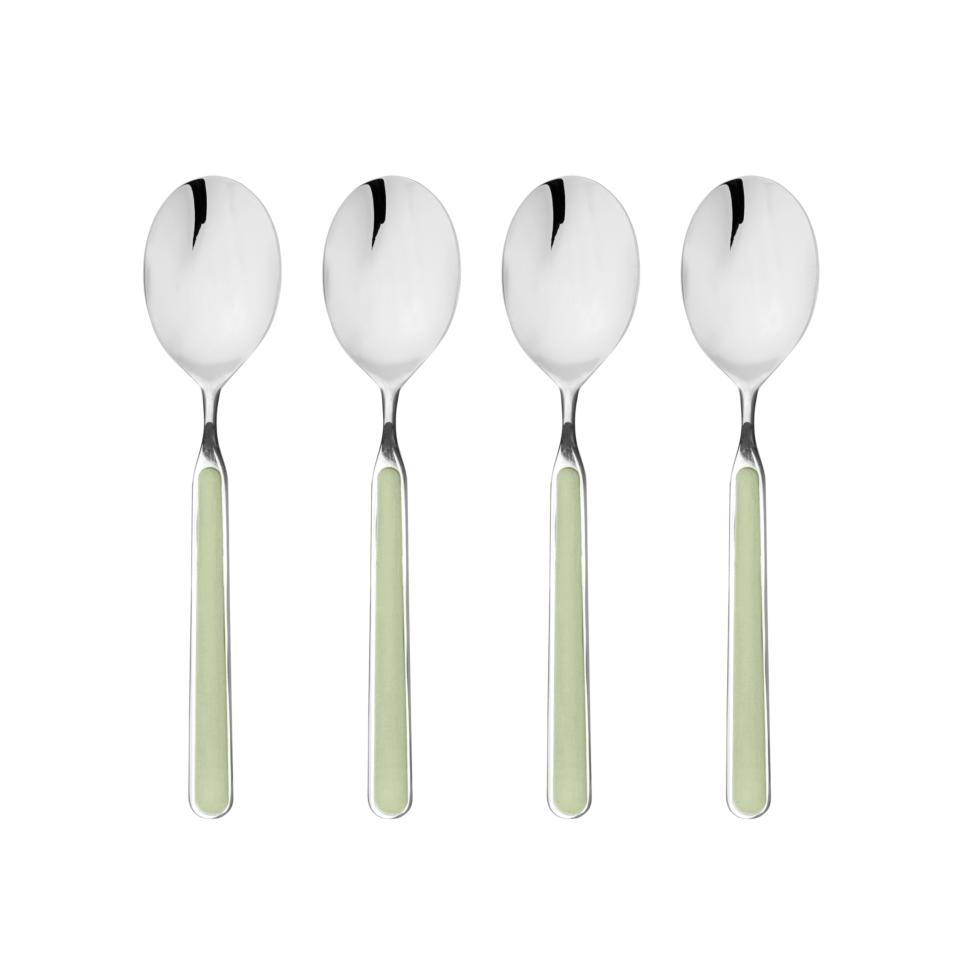 Four silver spoons with light green handles on a white background