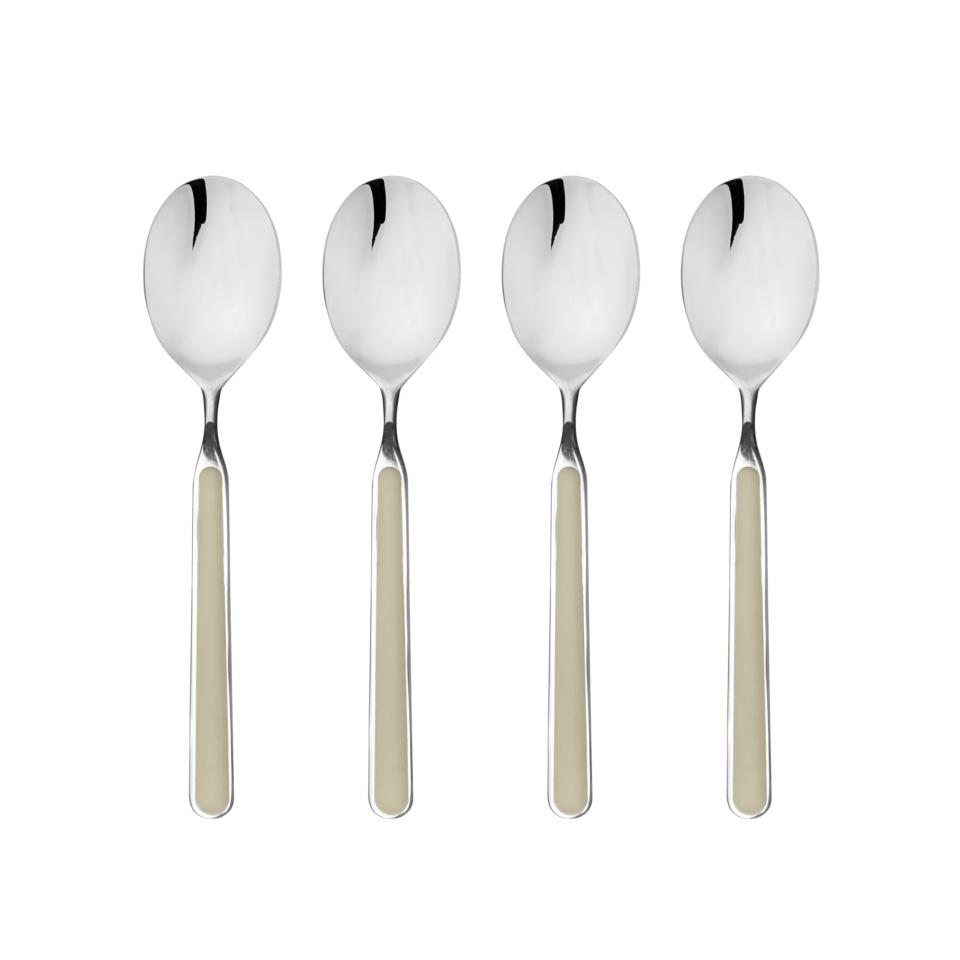 Four silver spoons with beige handles on a white background