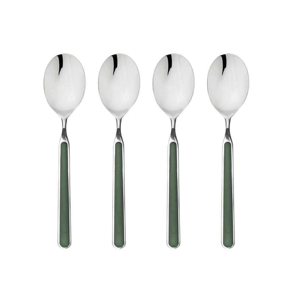 Four silver spoons with green handles on a white background
