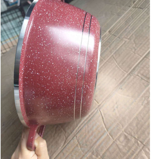 Red speckled cookware on a tiled floor