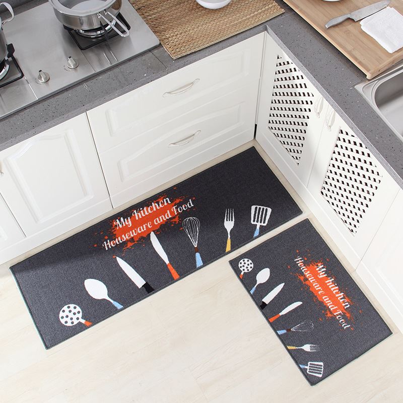 Two kitchen mats with utensil designs on a kitchen floor.