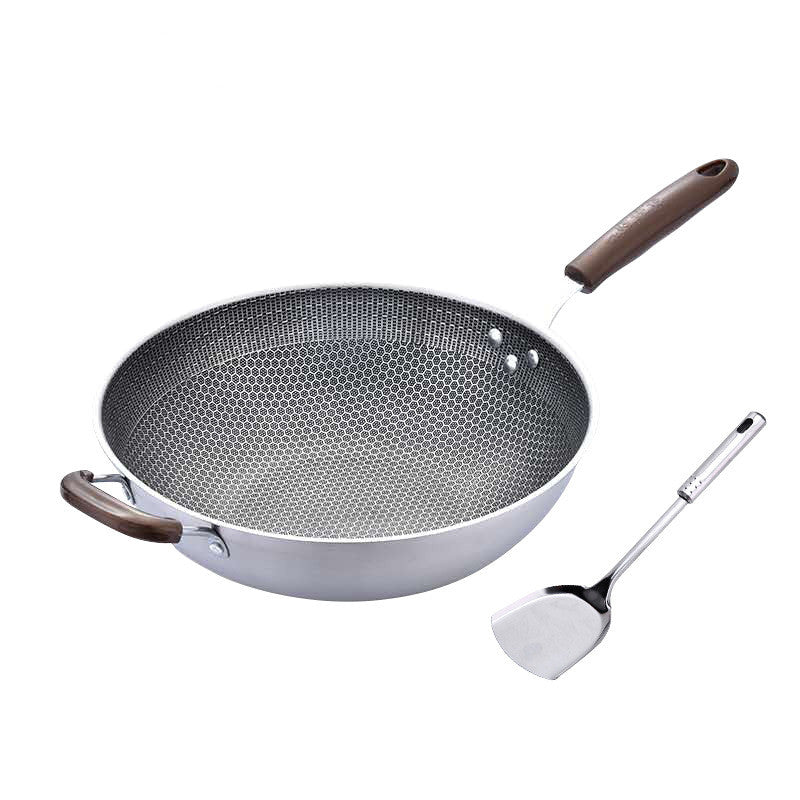 Wok with wooden handle and spatula on a white background