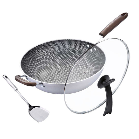 Wok with wooden handle, spatula, and glass lid on a white background