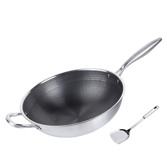 Stainless steel wok with a spatula on a white background