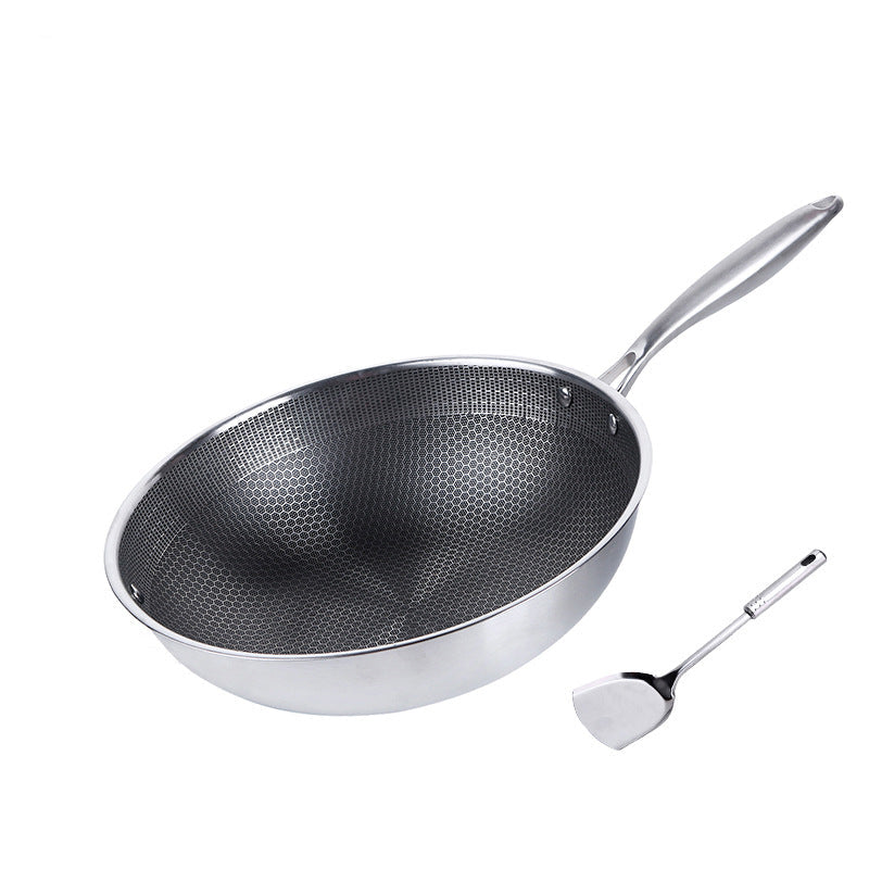 Stainless steel wok with a spatula on a white background