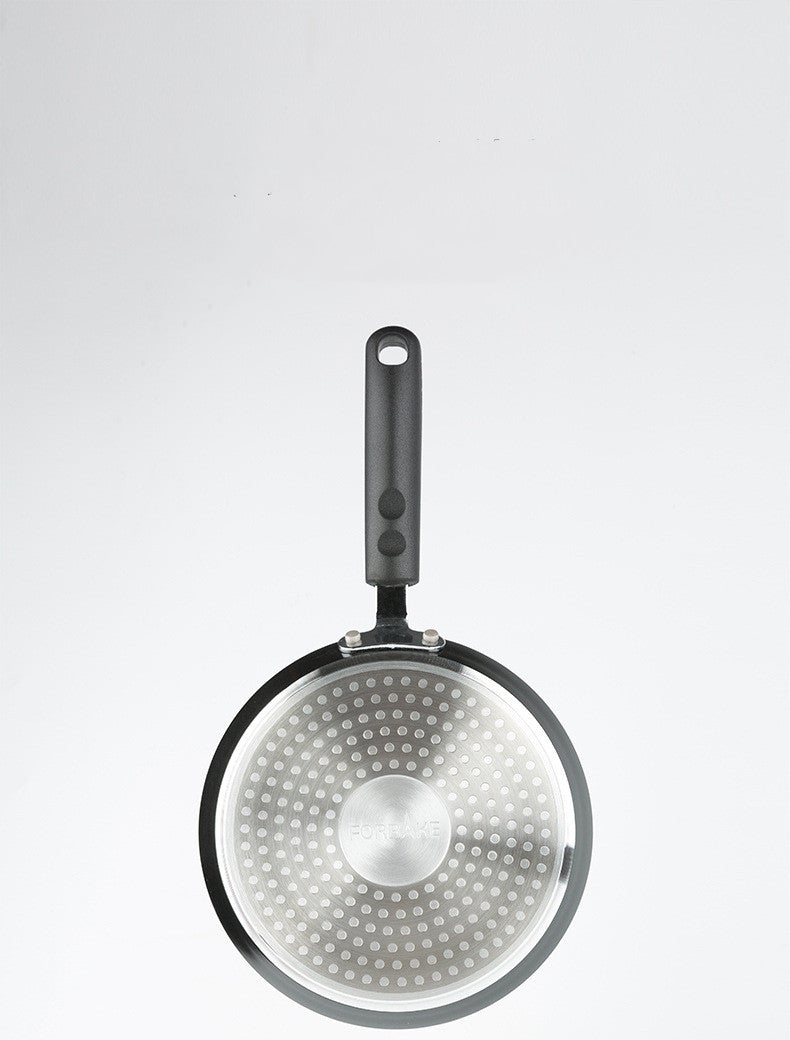 Frying pan with a perforated bottom on a white background