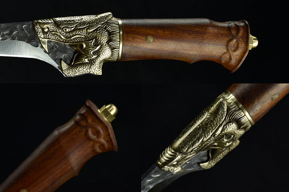 Decorative knife with wooden handle and gold embellishments on a black background